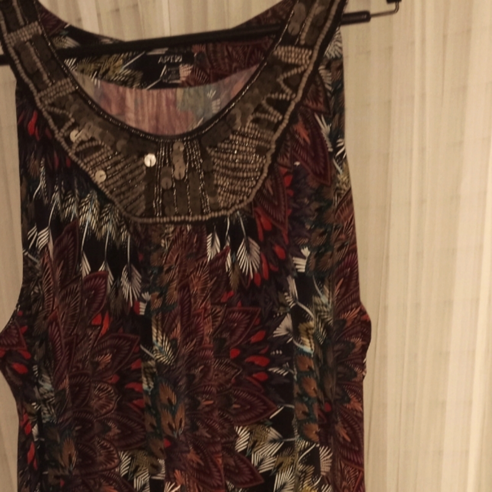 Beautiful dress for the summer the front has little wooden stats with copper